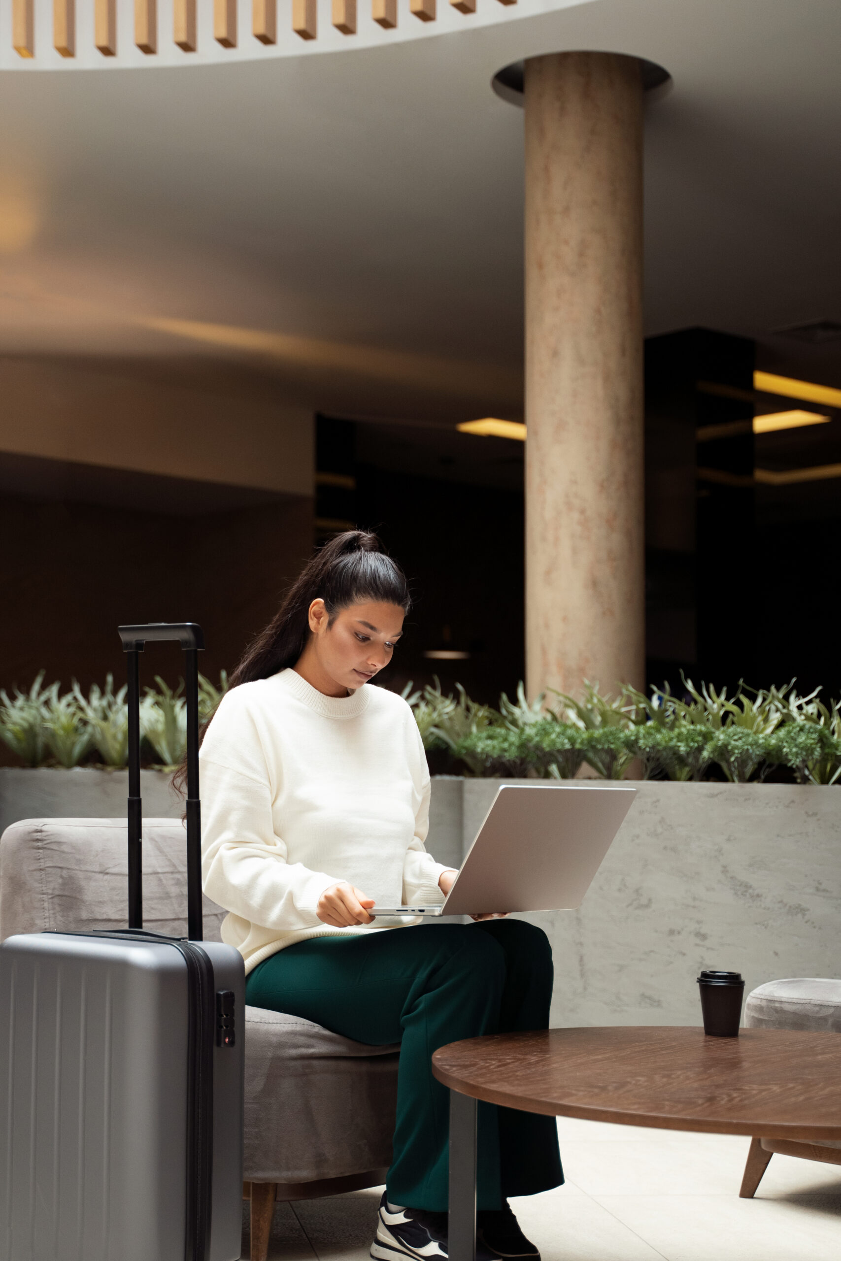 full shot woman working laptop